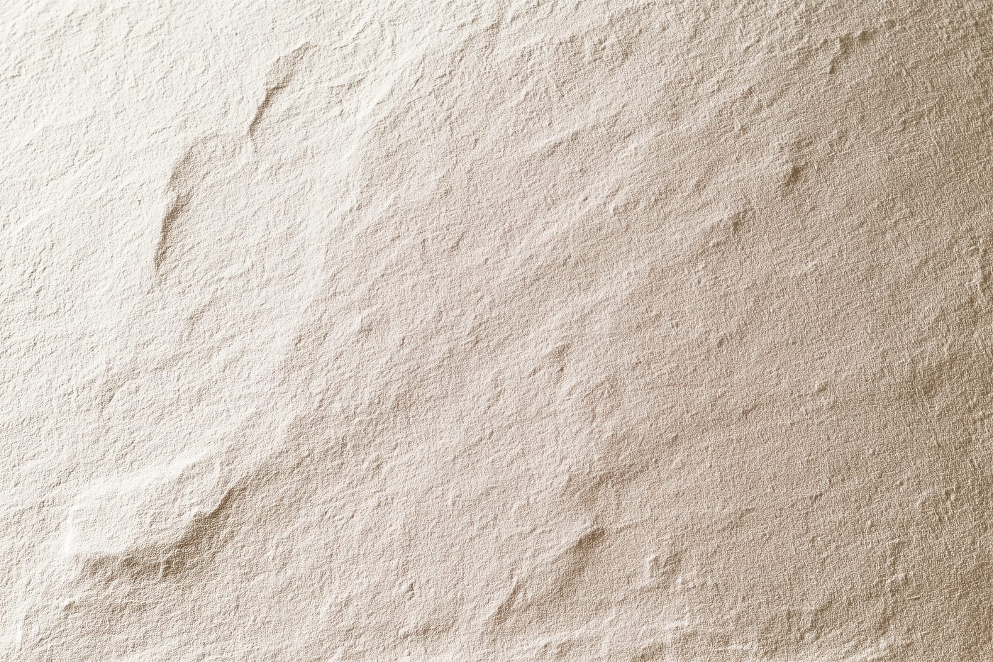 A weathered stone surface in soft raking light